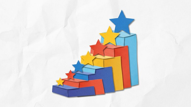 A paper staircase where each step carries a star, and the stars get bigger toward the top.